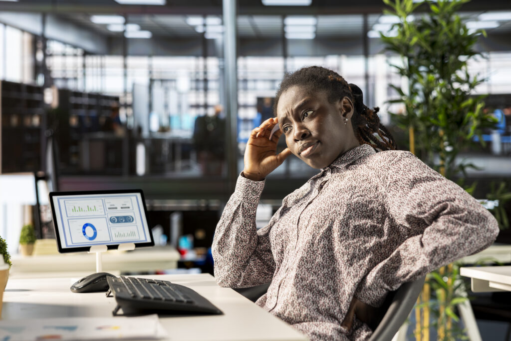 A business owner looking confused while reviewing sales and customer data on a dashboard — customer retention for retailers means making sense of scattered numbers